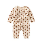 Baby onesie with brown bear pattern on a beige background