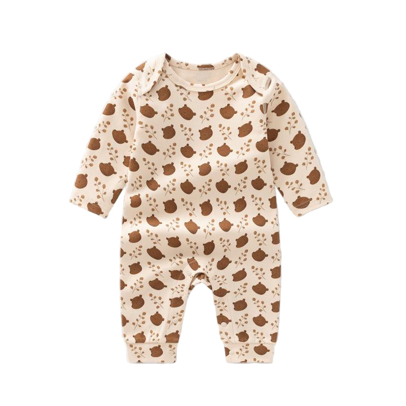 Baby onesie with brown bear pattern on a beige background