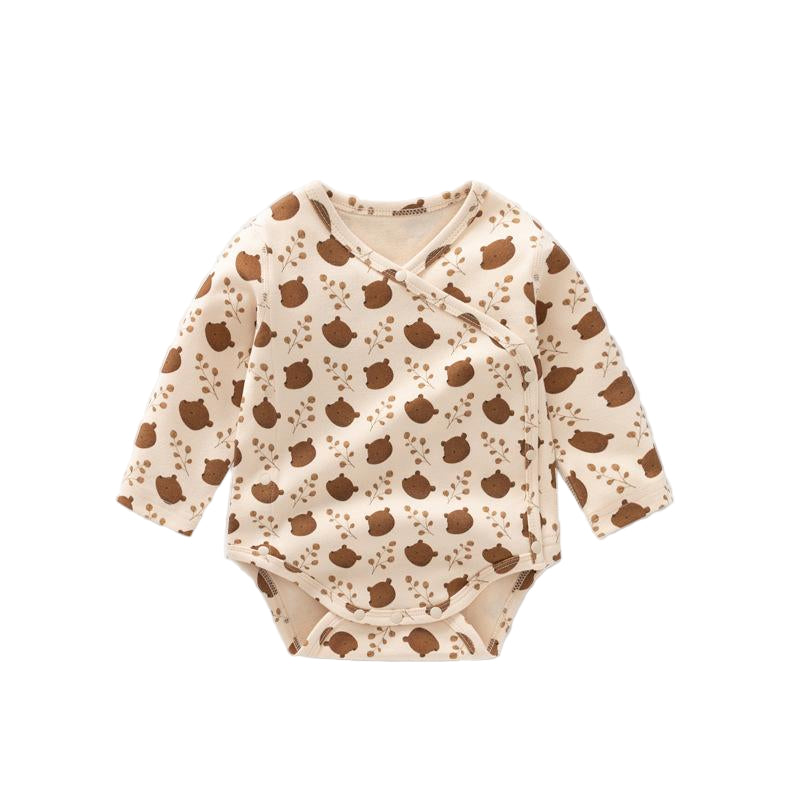 Baby onesie with brown apple pattern on a white background